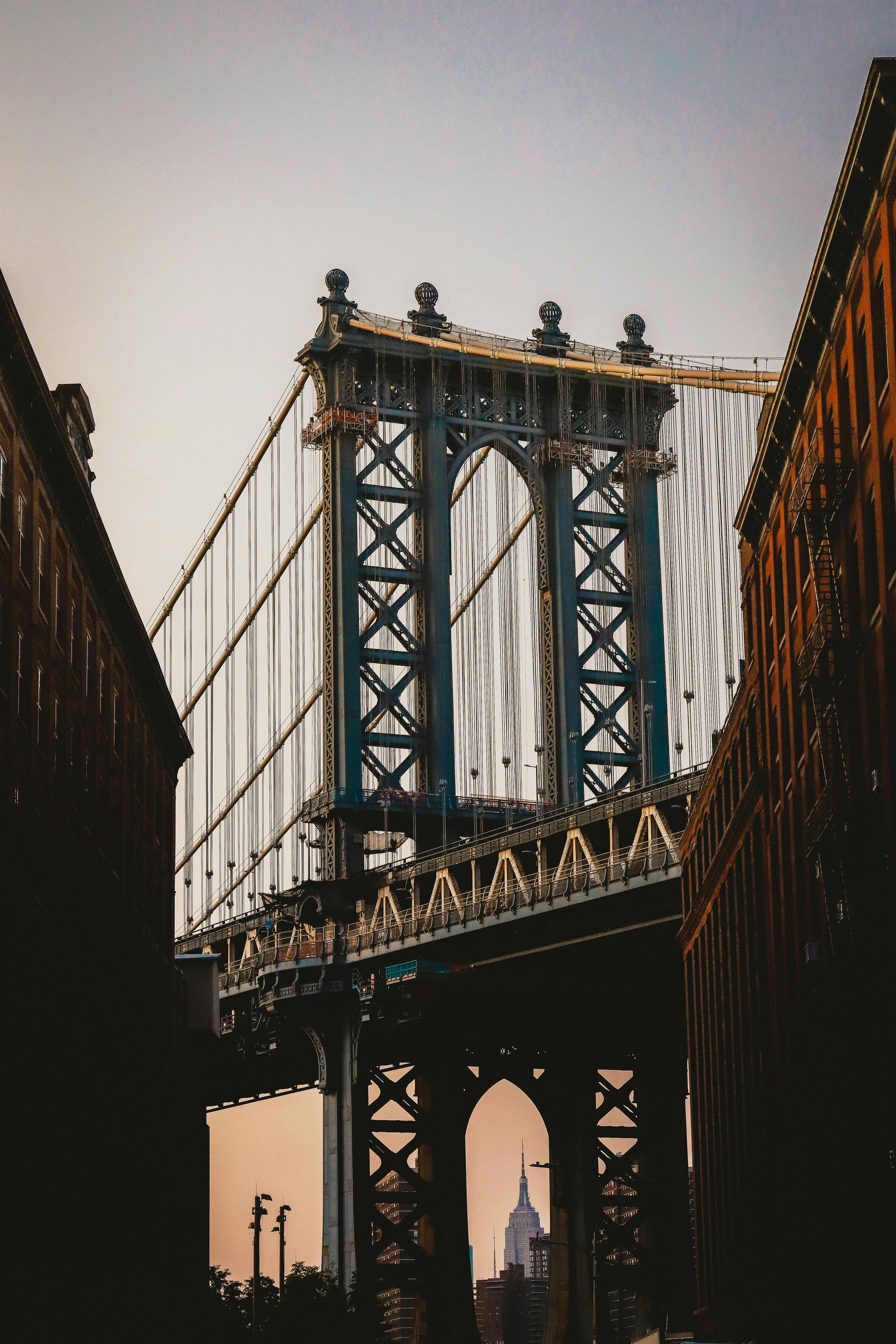 old brooklyn bridge under white sky at sunset