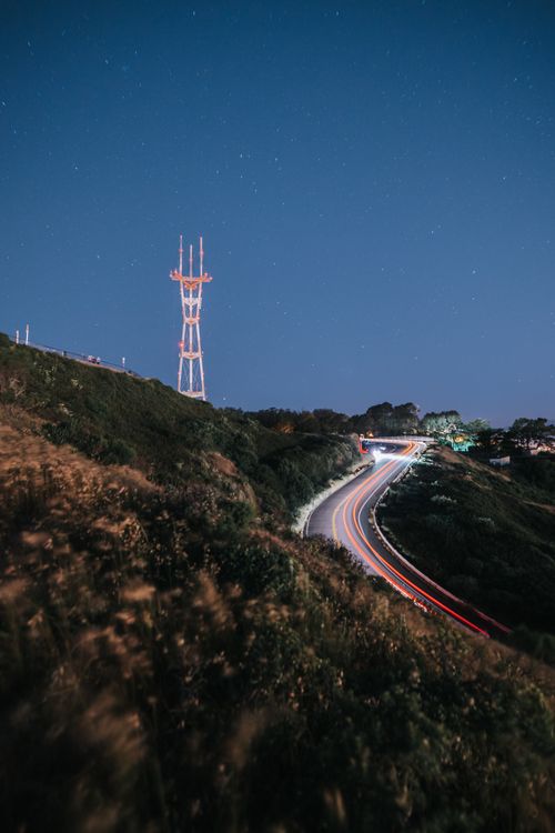 Free Captivating long exposure of San Francisco hillside with Sutro Tower and light trails at night. Stock Photo