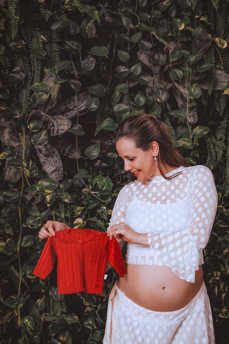 Happy Stylish Pregnant Woman With Bright Shirt For Kid