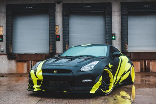 Free Modern sport automobile with expressive design of body on stone surface near building Stock Photo