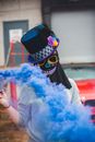 Anonymous woman in blue smoke