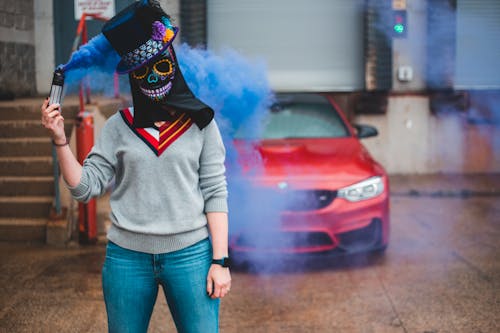 Unrecognizable woman with smoking flare