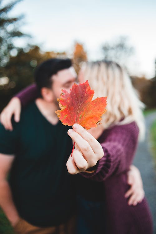 Unrecognizable couple kissing in park