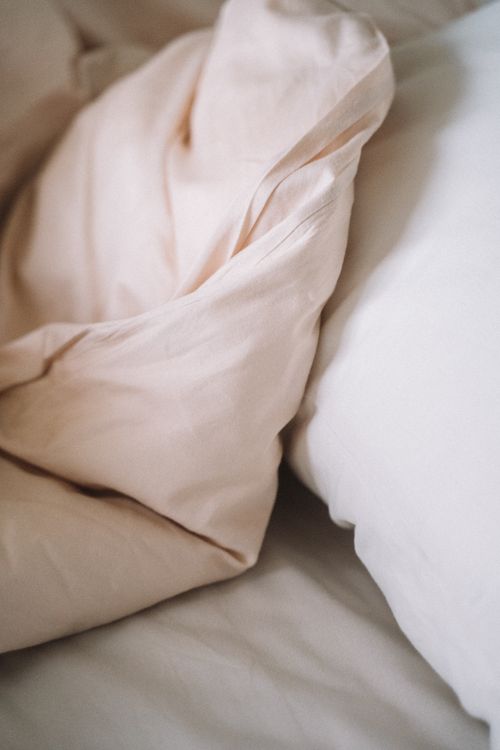 Free Close-up of soft, crumpled bed linen fabric in a cozy setting. Stock Photo