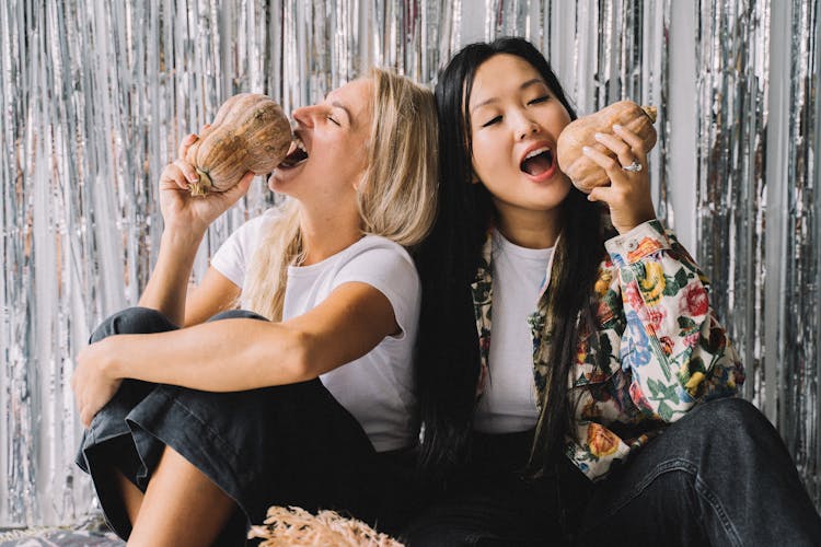 Photo Of Women Holding Squashes