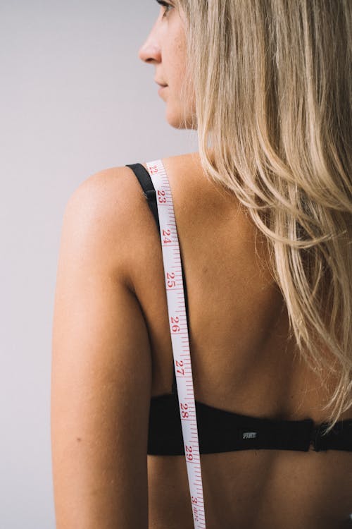 Photo of a Tape Measure on a Woman's Back