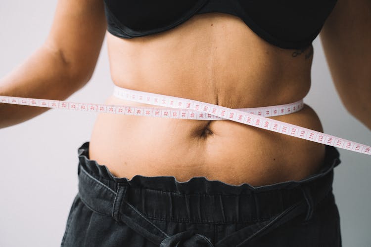 Photo Of A Tape Measure On A Person's Waist