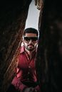 Portrait of Man Looking Through a Gab Between the Rocks 