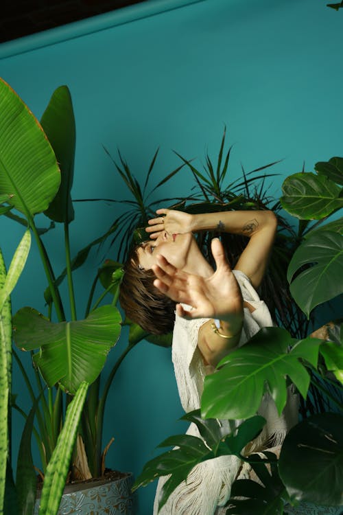 Free Photo of a Woman Posing Near Green Plants Stock Photo