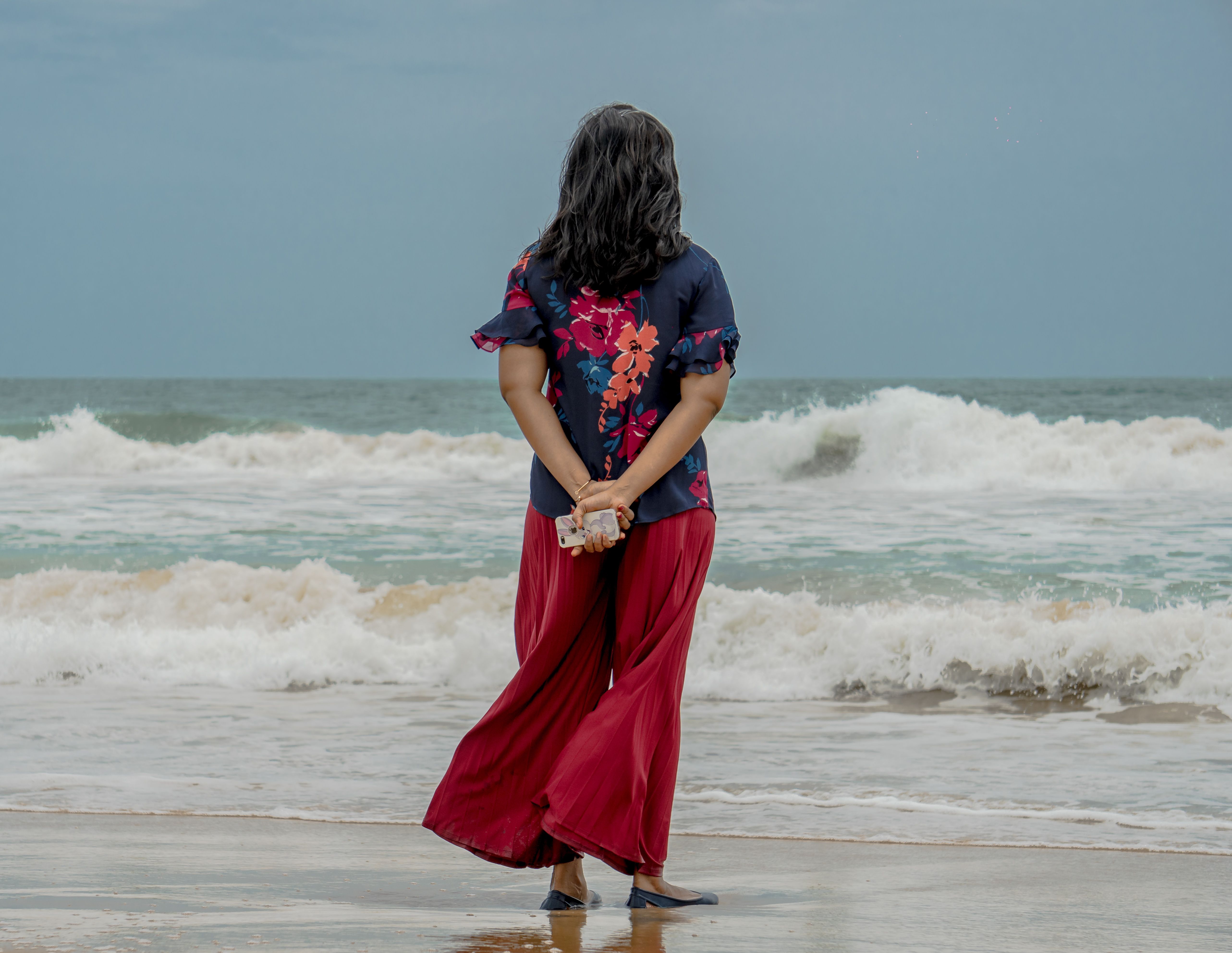A Woman in Red and Blue Floral Shirt Standing on the Beach · Free Stock ...