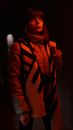 Female photographer standing in red light