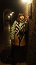 Contemplative female photographer leaning on wall