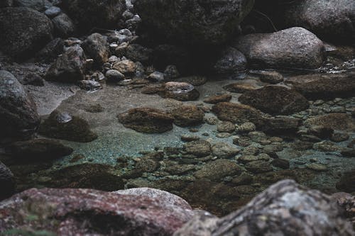 Rough stones in pure sea water in daylight