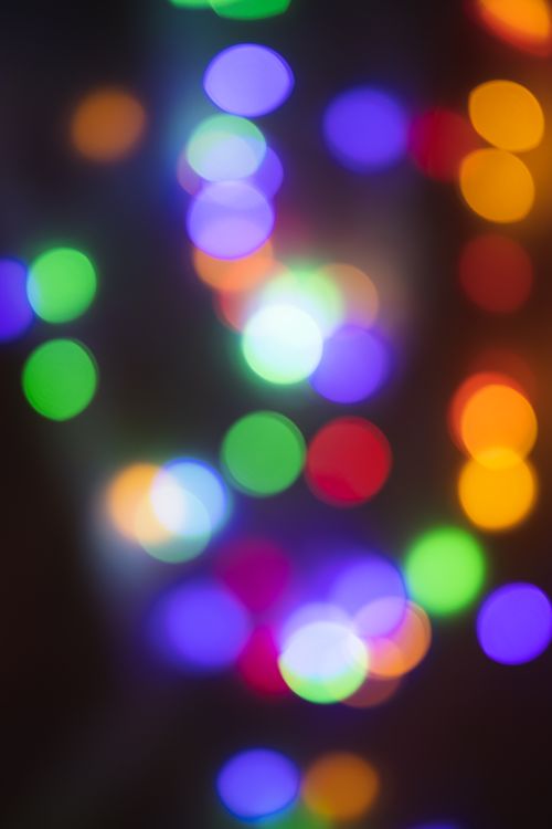 Free Vibrant multicolored bokeh lights create an abstract and festive atmosphere. Stock Photo