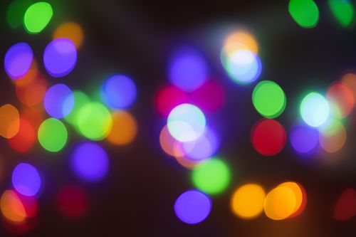 Free Colorful bokeh lights create a vivid, abstract background with a dark backdrop. Stock Photo