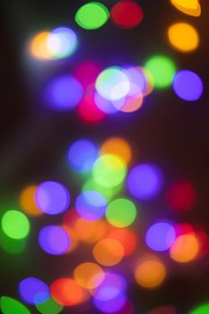 A blurred view of colorful bokeh lights creating a festive ambiance.
