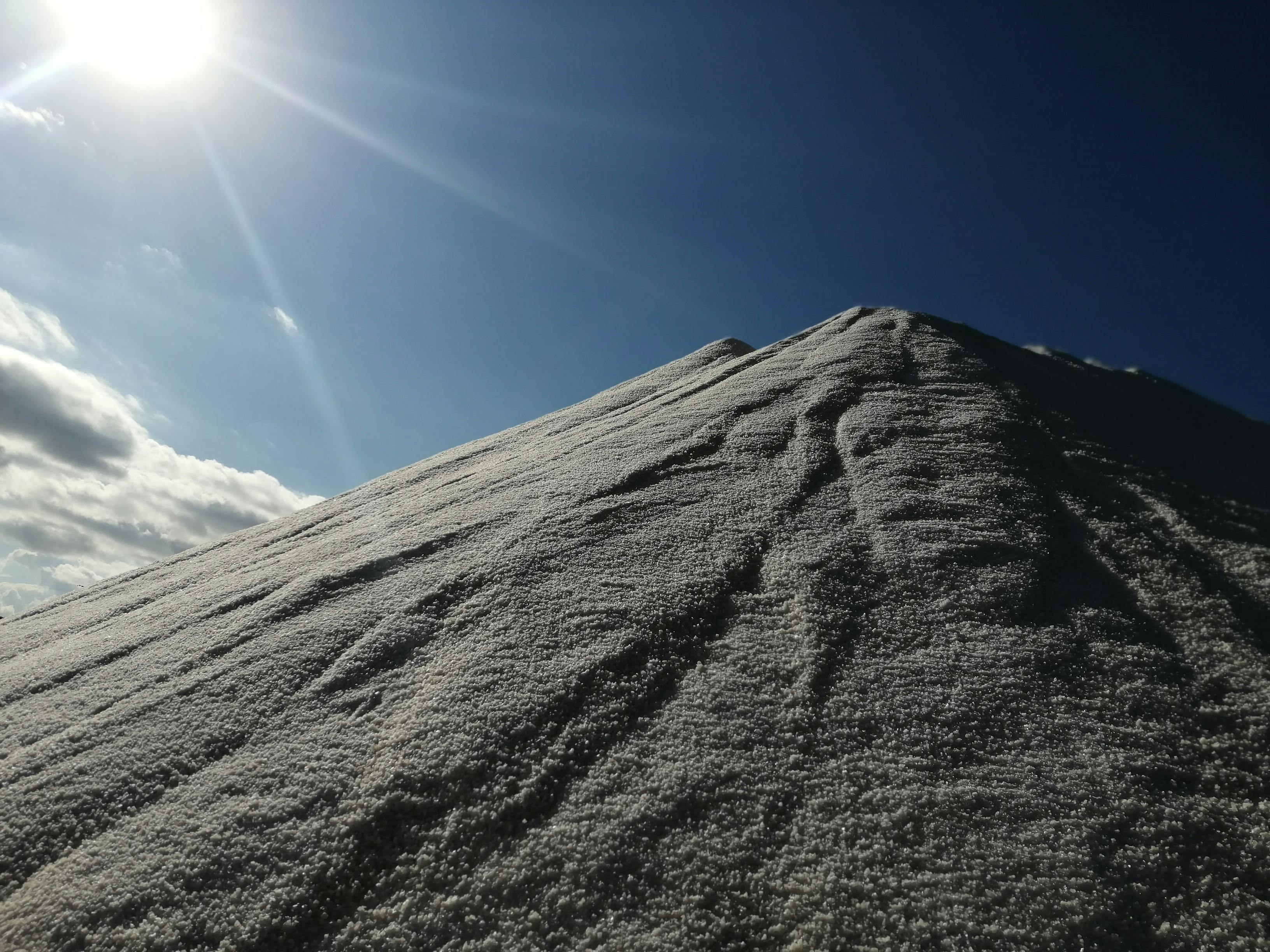 Campfire at night on a beach, evoking Survivor camp life and alliance talks