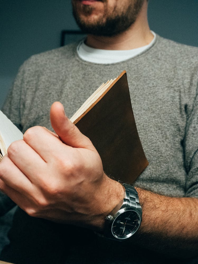 Crop Male Reading Opened Diary