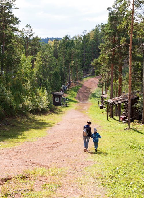 Mother and Child Walking on Dirt Road