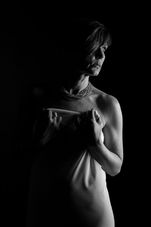 Free Dramatic black and white portrait of an elegant woman with moody lighting. Stock Photo