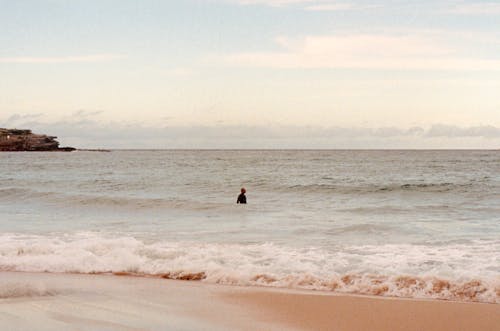 A Man Surfing on the Beach