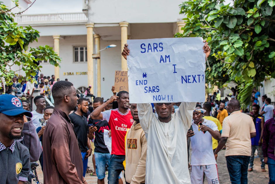 A group of men protesting against SARS in Nigeria, holding signs and banners expressing their demands for change.