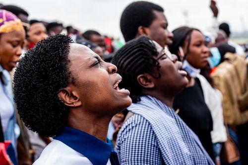 Free A diverse group of people passionately singing together outdoors. Stock Photo