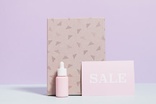 Healthcare Product In Pink Bottle With Printed Paper Bag On Sale 