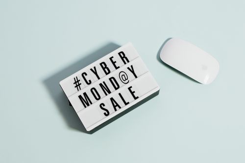 Free Lightbox sign displaying 'Cyber Monday Sale' beside a computer mouse on a pastel background. Stock Photo
