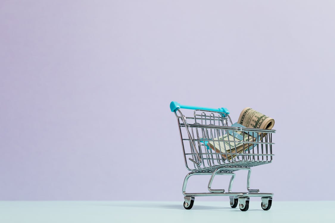 Free Cash Inside a Tiny Shopping Cart Stock Photo