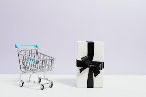 Shopping Cart Next to a Gift Box