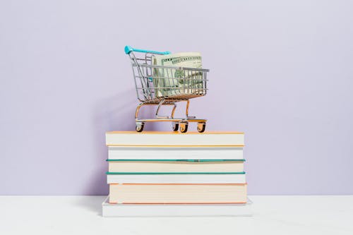 Shopping Cart on Top of Books