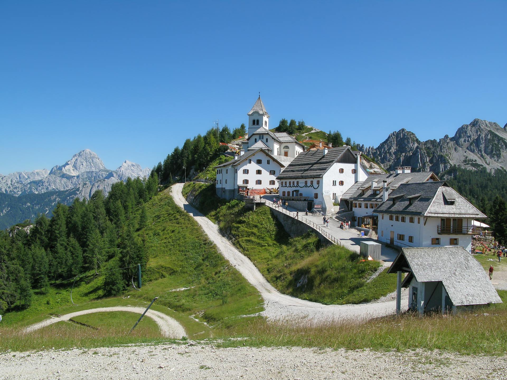 Scenic view of a mountain village with a church in Friuli Venezia Giulia, Italy.