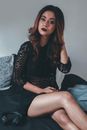 Woman in Black Long Sleeve Shirt Sitting on Couch
