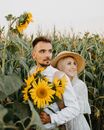 Man in White Long Sleeve Shirt Holding Sunflower