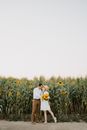 Woman in White Dress Standing on Flower Field