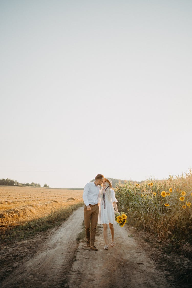 Man And Woman Walking And Kissing