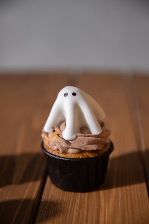 Free Cupcake with Ghost Topper on the Table Stock Photo