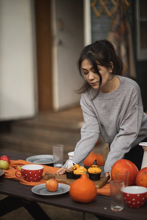 Free Woman in Gray Long Sleeve Shirt Setting the Table Stock Photo
