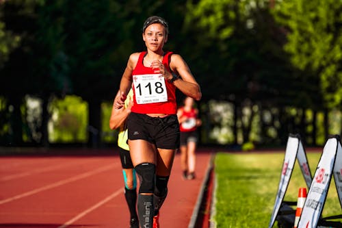 Free Concentrated ethnic sportswoman running on race track during competition Stock Photo