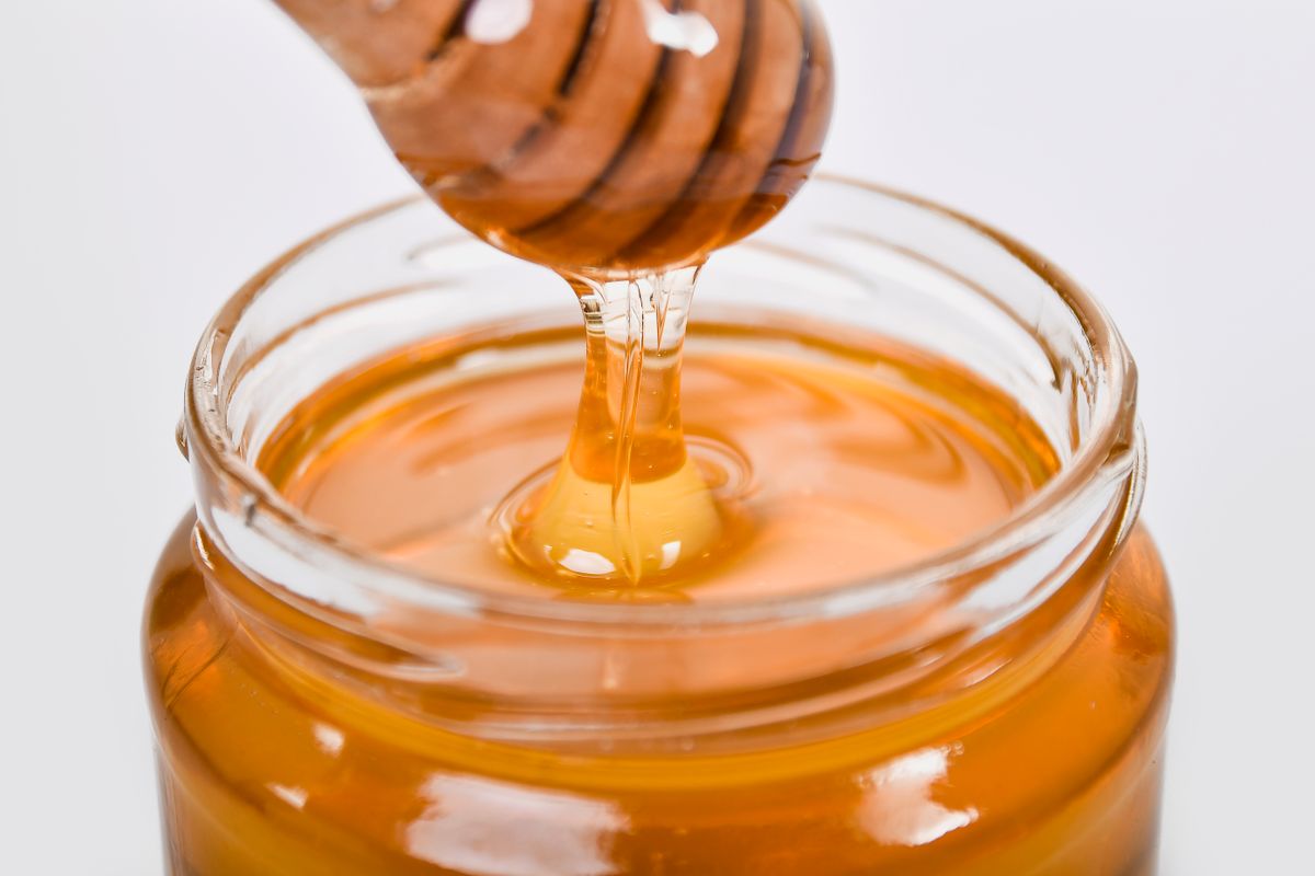 Liquid golden honey in a glass jar, artisan honey to buy in the UK