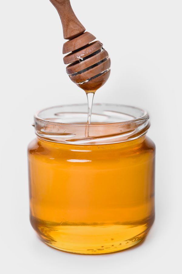 Clover honey drizzling into a jar — photo by Adonyi Gábor on Pexels
