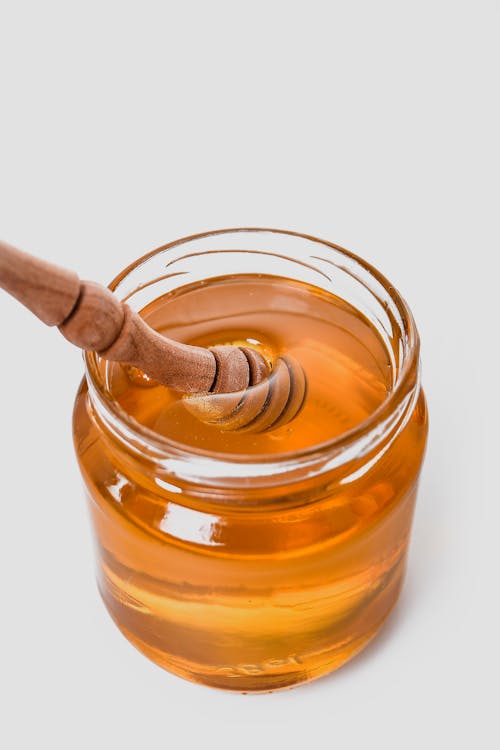 Clear Glass Jar filled with Honey 