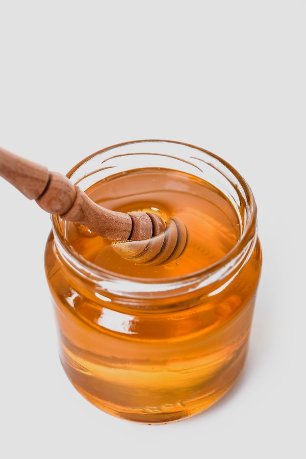 Raw wildflower honey in a glass jar — photo by Adonyi Gábor on Pexels
