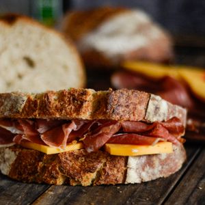Rustic ham and cheese sandwich on a wooden table — photo by Raul Corrado on Pexels