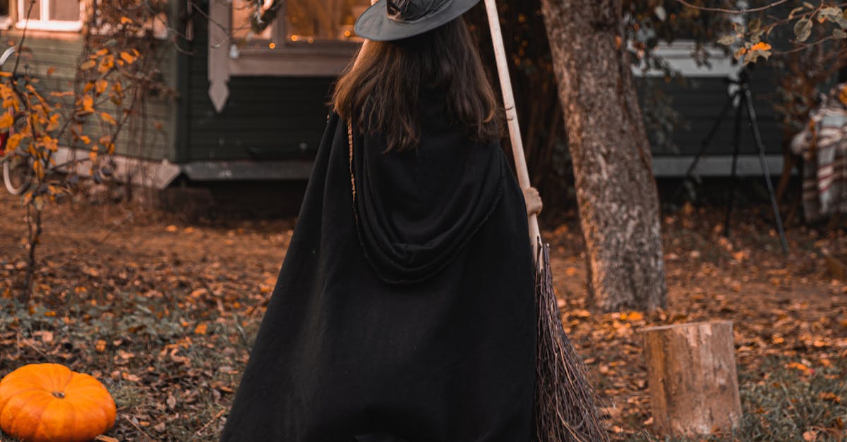 Woman in A Witch Costume With Pumpkins On The Ground · Free Stock Photo