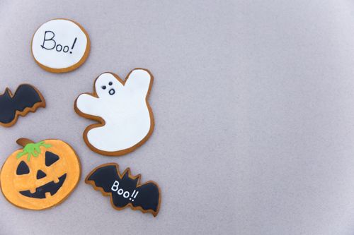 Free Assorted Halloween cookies featuring ghost, pumpkin, and bat designs with 'Boo' text for a festive celebration. Stock Photo