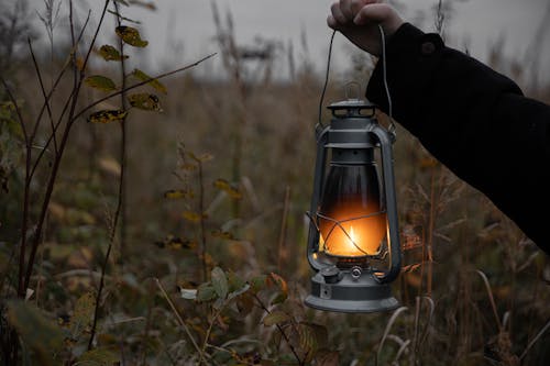 Person Holding A Lantern With Fire