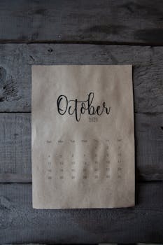 A minimalist October 2020 calendar on a rustic wooden surface, evoking fall simplicity.