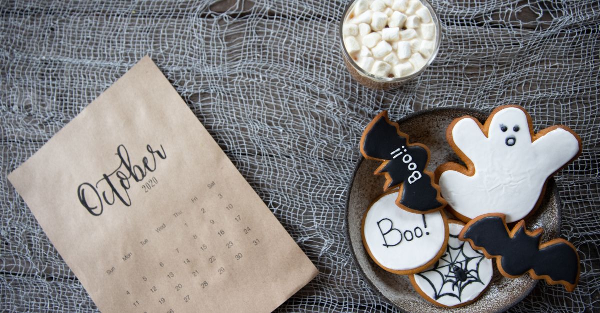 Halloween themed cookies and October calendar on a rustic background, perfect for festive holiday design
